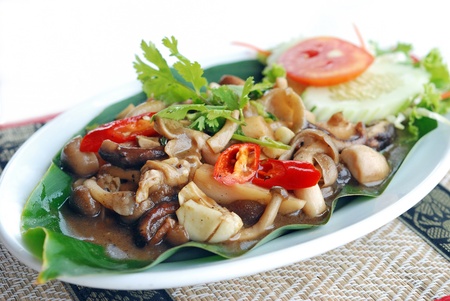 close up stir fried mushroom with pepper sauce on banana leafの写真素材