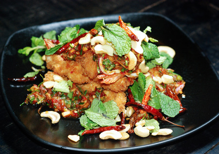deep fried fish with herb spicy saladの写真素材