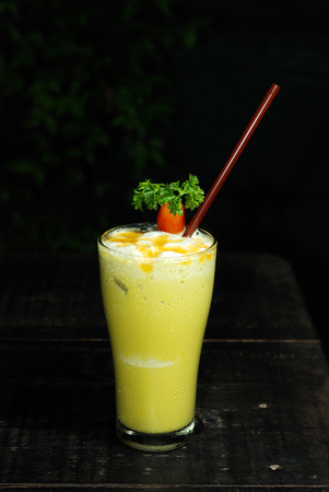 mango milkshake on wood table and black の写真素材