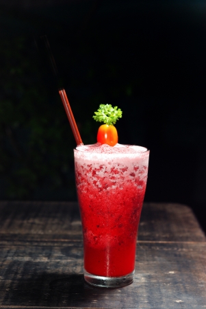 strawberry smoothie on wooden table and black の写真素材