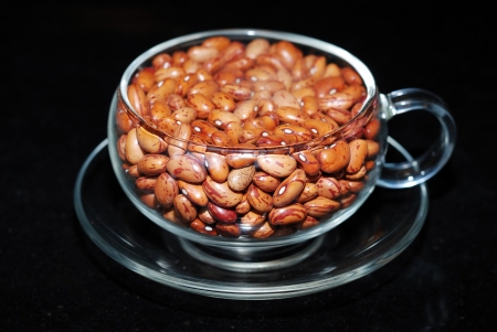 close up full of cranberry bean in glass cup on black の写真素材