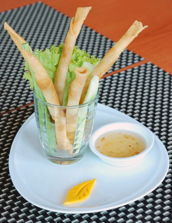 deep fry spring rolls in glass with sweet and sour sauceの写真素材