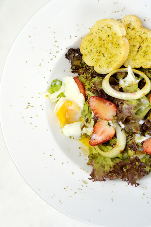 Homemade fresh mix vegetable salad with egg on white backgroundの写真素材