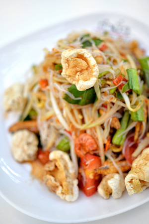 Spicy papaya salad with crispy pork skinの写真素材