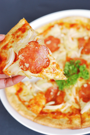 Homemade hot pizza sliced with pepperoniの写真素材