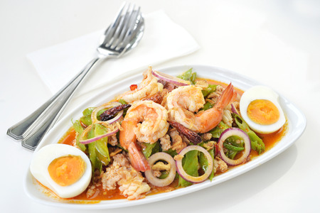 Selective focus of spicy seafood salad with egg, Thai foodの写真素材