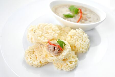 Crispy rice crust pile with sweet pork sauceの写真素材
