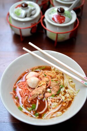 Egg noodle soup with pork ball and braise porkの写真素材