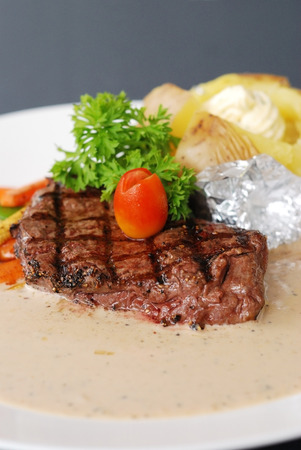 Beef steak with cream sauce and potatoの写真素材