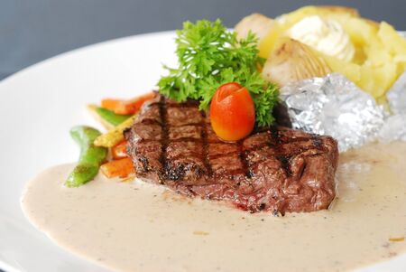 Beef steak with cream sauce and potatoの写真素材