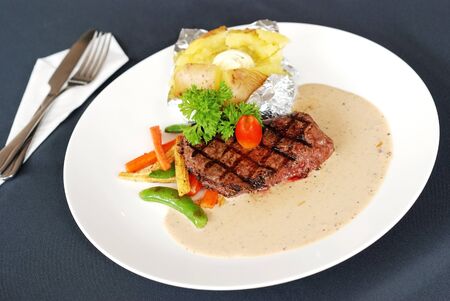 Beef steak with cream sauce and potatoの写真素材
