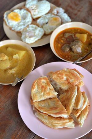 Selective focus of indian bread or roti with various curry and fry egg, Indian foodの写真素材