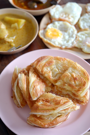 Selective focus of indian bread or roti with various curry and fry egg, Indian foodの写真素材
