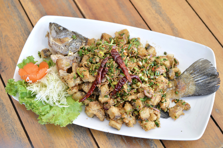 Selective focus of fry fish fillet with spicy herb and chiliの写真素材