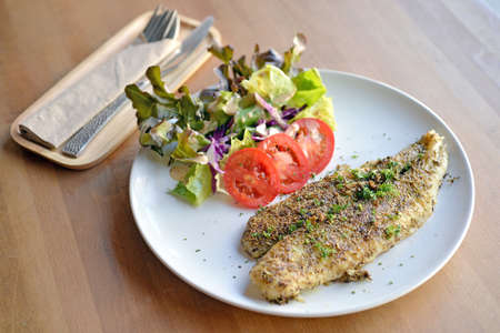 Selective focus of grill fish fillet with herbの写真素材