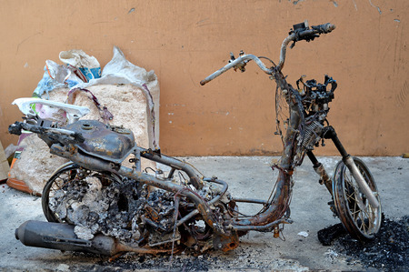 Selective focus of burnt motorcycle in riot accidentの写真素材
