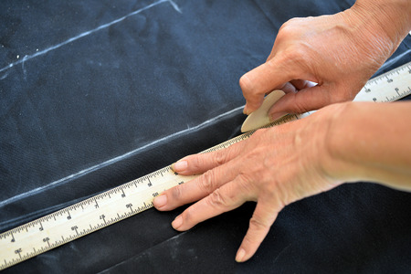 Close up measure on cloth with hand, tailor workの写真素材