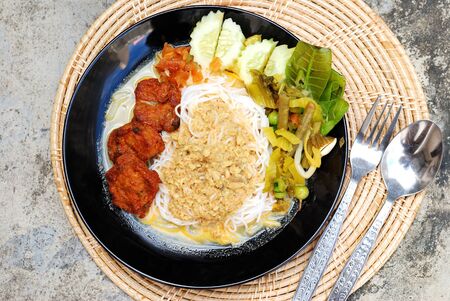 Thai rice noodles, Fermented Rice Flour Noodles with fish curry and fish cakes, selective focusの写真素材