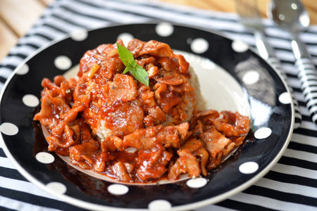 Stir fry pork with kimchi sauce on rice, Korean food, selective focus