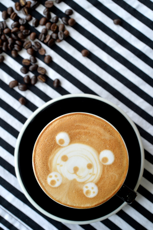 Bear drawing in coffee art cup with coffee beans, selective focusの写真素材