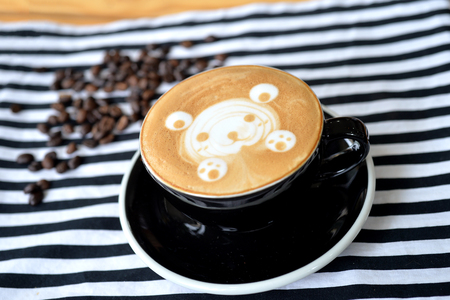 Bear drawing in coffee art cup with coffee beans, selective focusの写真素材