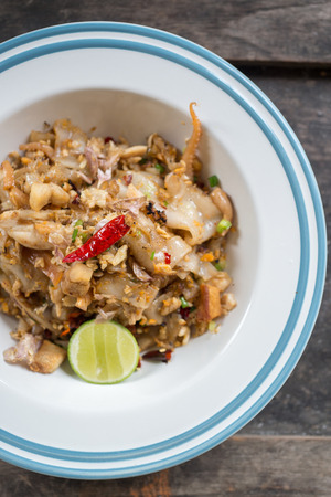 Stir fried rice noodle with chicken and egg, famous Thai food, selective focusの写真素材