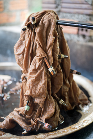 Close up dying cloth with brown colorの写真素材