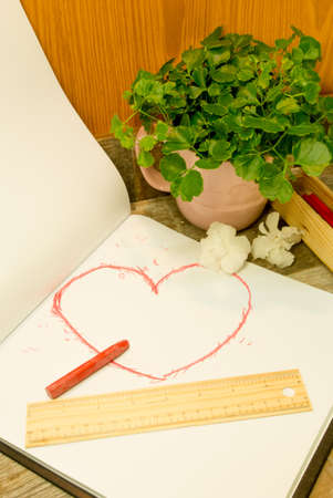 Hand draw style heart shape in red color on sketchbookの写真素材
