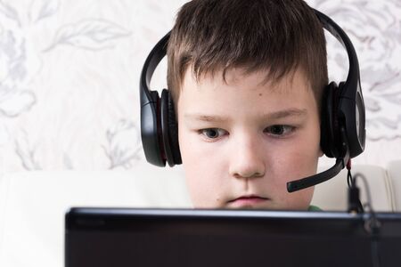 Surprised Teenager with Tablet Computer with headphonesの写真素材