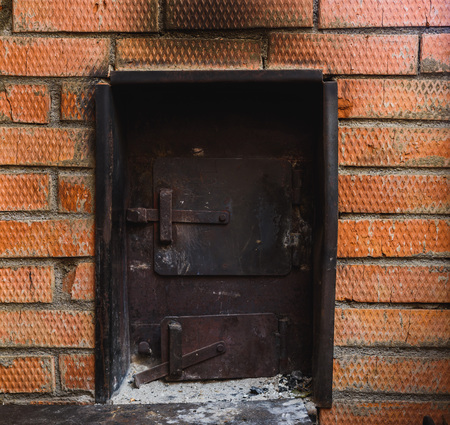 iron stove in the Russian bath lined with red brickの写真素材