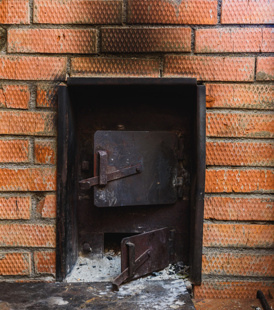 iron stove in the Russian bath lined with red brickの写真素材