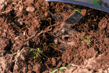 Motor-cultivator at the ploughed gardenの写真素材