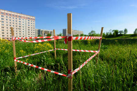 Warning tape attached to a wooden poleの写真素材