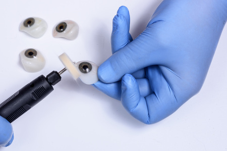 polishing an eye prosthesis in a prosthetic clinicの写真素材