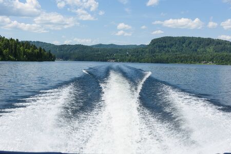 a trip along Teletskoye Lake on a motorboat in the Altai Mountainsの写真素材