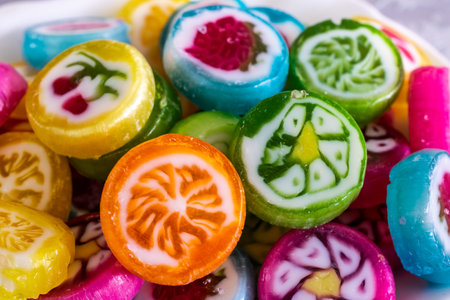 Colorful candy sweets close up, selective focus. Different tastes and drawings of fruits on candies,...