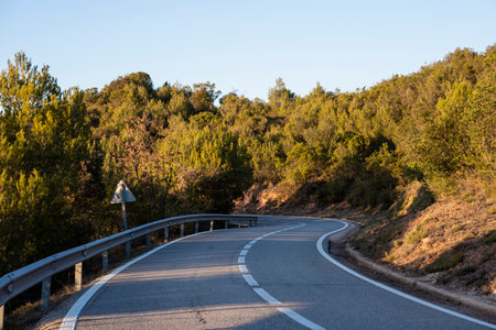 lonely mountain road with curves in autumnの写真素材