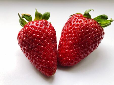 Two fresh strawberry on white background. close up, top view.の写真素材