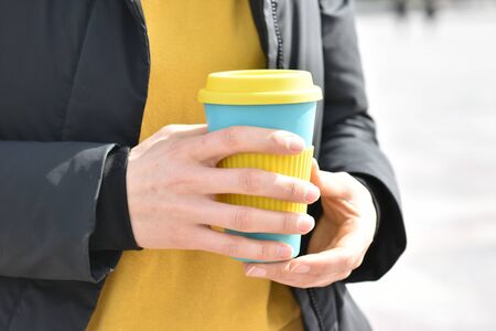 Woman hand holds eco coffee cup.Sustainable lifestyle concept.の写真素材