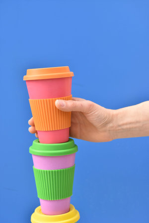 One womans hand taking eco coffee cup. Zero waste concept.