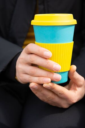 Female hands hold reusable coffee mug.Sustainable lifestyle concept.の写真素材