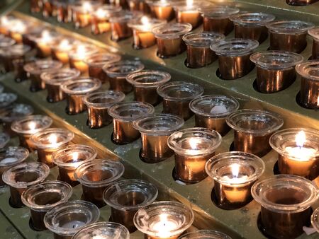 Rows of candles inside of the Milan Cathedral Milanの写真素材