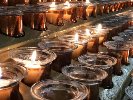 Rows of candles inside of the Milan Cathedral Milanの写真素材