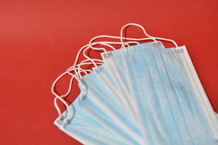 Medical protective mask on red background. Healthcare concept