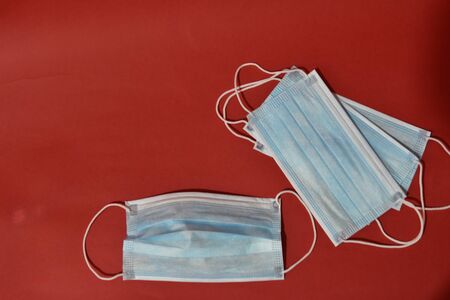 Medical protective mask on red background. Healthcare conceptの写真素材