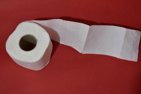 Roll of toilet paper on red backgroundの写真素材