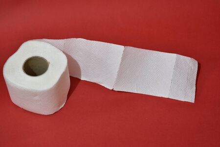 Roll of toilet paper on red backgroundの写真素材