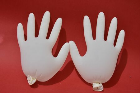 Medical gloves white color isolated on red background. protectionの写真素材