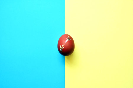  Easter egg on blue and yellow minimalist background ..Easter Element.Top View,Flat lay,copy space.
