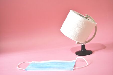 Basic consumer product coronavirus concept.Toilet paper and face maskの写真素材